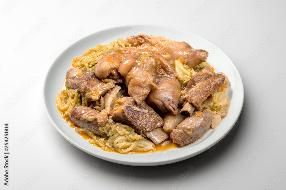 White plate with pork meat and savoy cabbage White plate with pork meat and savoy cabbage