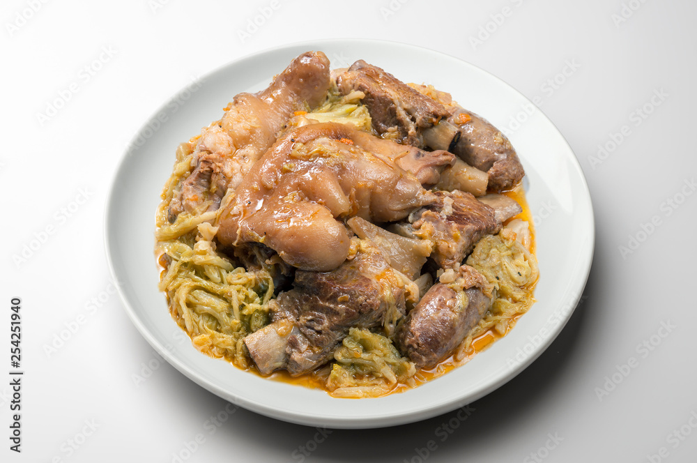 White plate with pork meat and savoy cabbage White plate with pork meat and savoy cabbage