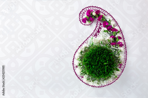 Novruz concept samani or semeni or sabzi for spring equinox March celebration in buta shape, paisley pattern motive, oriental style, nowruz or navruz background, copy space for text