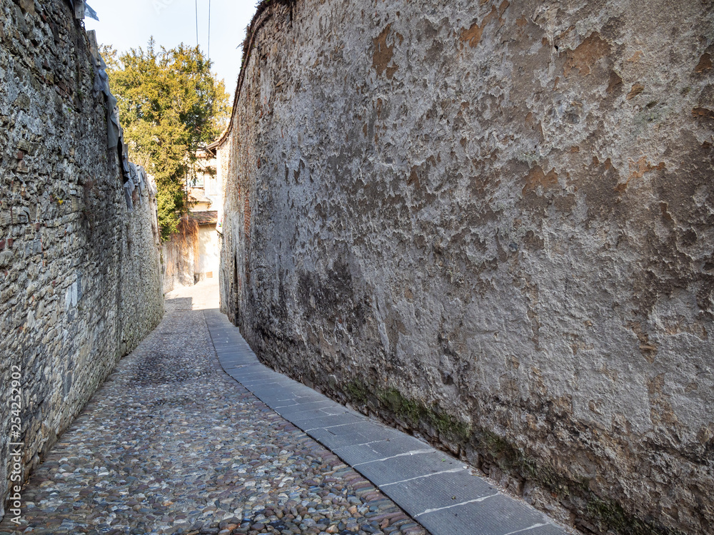 narrow street between old walls in Bergamo town