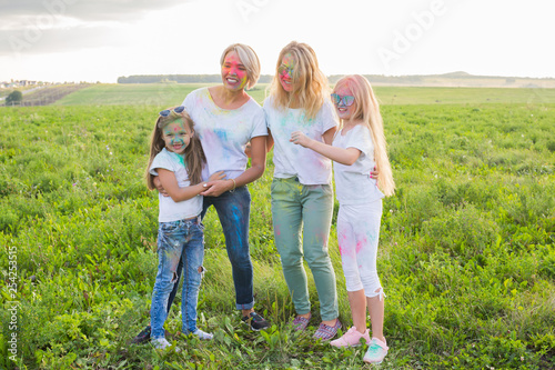 Holiday, summer and fun concept - Group of people dancing in field at holi festival