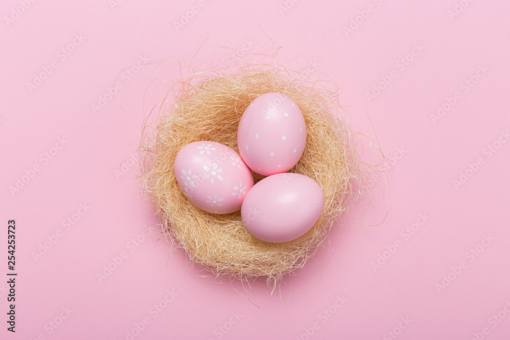 Pink easter eggs in nest on pastel color background with space. Concept Pink easter eggs in nest on pastel color background with space. Concept