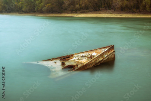 Rusty shipwreck in the river Danube photo