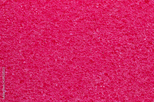 Sponge texture background. Close-up of red bath sponge texture with porous structure for background. Macro. photo