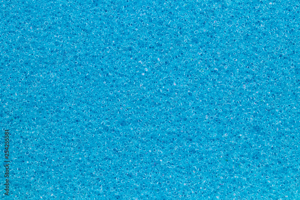 Sponge texture background. Close-up of blue bath sponge texture with porous structure for background. Macro. Sponge texture background. Close-up of blue bath sponge texture with porous structure for background. Macro.
