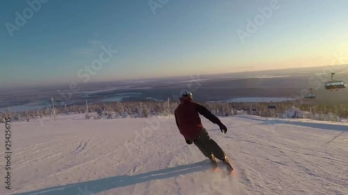 Video of a skier enjoying the beautiful slopes in the south park of the ski resort in Levi, Finland. photo