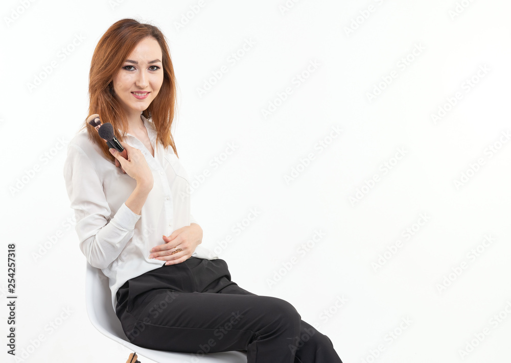 Attractive visagist or korean make-up artist holding a makeup brushes on white background Attractive visagist or korean make-up artist holding a makeup brushes on white background
