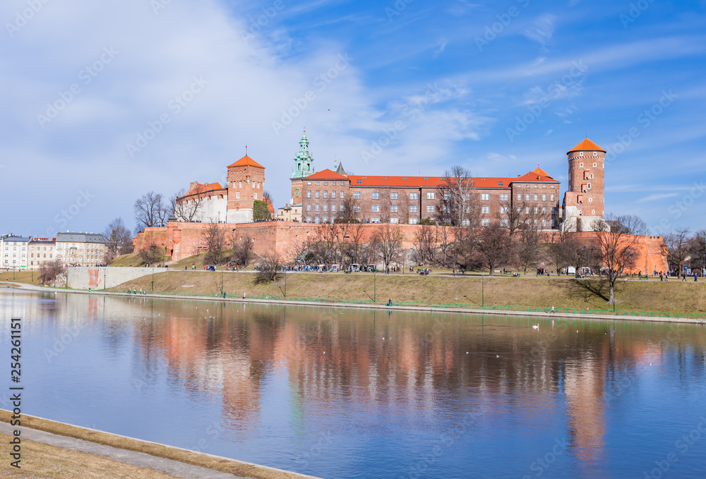 Wawel Royal Castle famous landmark in Krakow Poland. Picturesque landscape on coast river Vistula.  Blue sky and cloud. February 23, 2019.