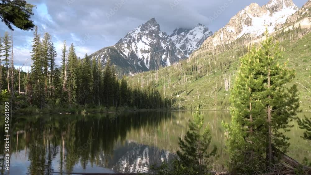 Slow zoom into Jenny Lake with snow capped peaks and pine trees in Grand Teton National Park, Wyoming Slow zoom into Jenny Lake with snow capped peaks and pine trees in Grand Teton National Park, Wyoming