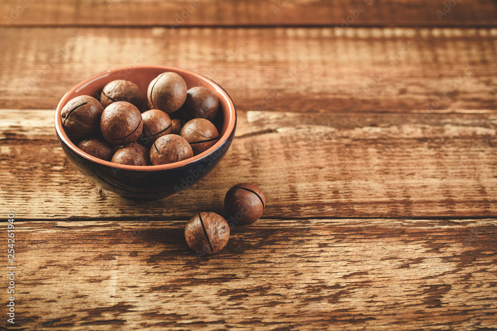 Macadamia nuts on wooden table Macadamia nuts on wooden table