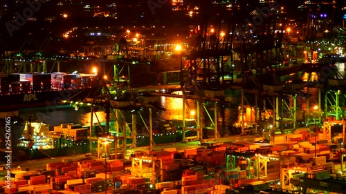 View of harbor unloading cargo from a container ship with cranes from above with transport bridge. Concept of Global business containers shipping,Logistic,Import and Export industry photo