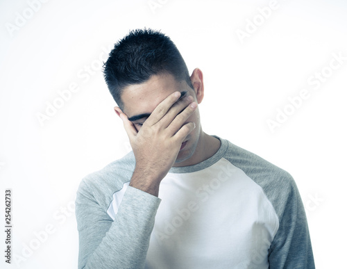 Close up portrait of sad young man face suffering from depression, stress and unhappiness.