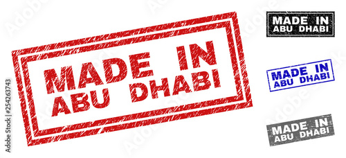 Grunge MADE IN ABU DHABI rectangle stamp seals isolated on a white background. Rectangular seals with grunge texture in red, blue, black and gray colors.