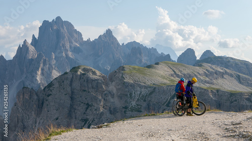 Two cyclists on MTBs in extreme mountain landscape