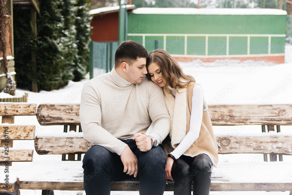 Winter love story on ice. Beautiful young guy and girl skating on ice Winter love story on ice. Beautiful young guy and girl skating on ice