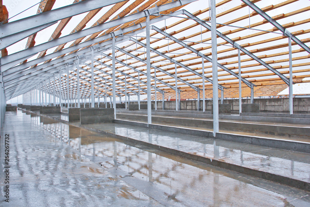 Wooden beams on a metal frame. Construction of agricultural buildings. The construction of the barn. Agriculture. Wooden beams on a metal frame. Construction of agricultural buildings. The construction of the barn. Agriculture.