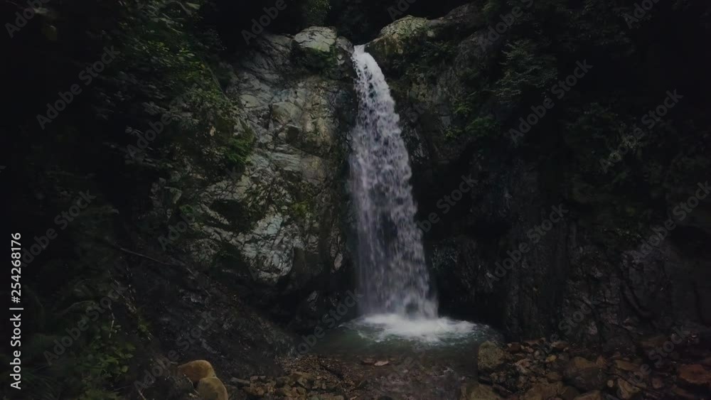 drone dolly forward towards waterfall, rocky place, dark light, in Turkey drone dolly forward towards waterfall, rocky place, dark light, in Turkey
