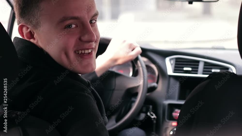 happy driver in car salon smiling and showing thumb up happy driver in car salon smiling and showing thumb up