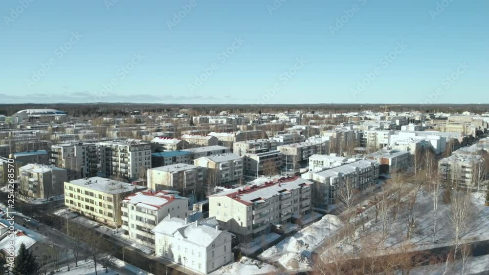 Aerial, pan, drone shot, around city streets, overlooking buildings and the cityscape, on a sunny, winter day, in Joensuu, North Karelia, Finland Aerial, pan, drone shot, around city streets, overlooking buildings and the cityscape, on a sunny, winter day, in Joensuu, North Karelia, Finland