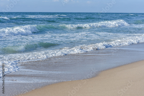 Sea, Blue waves with white foam, under the blue sky.