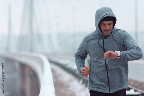 A man running across the bridge at the bad weather