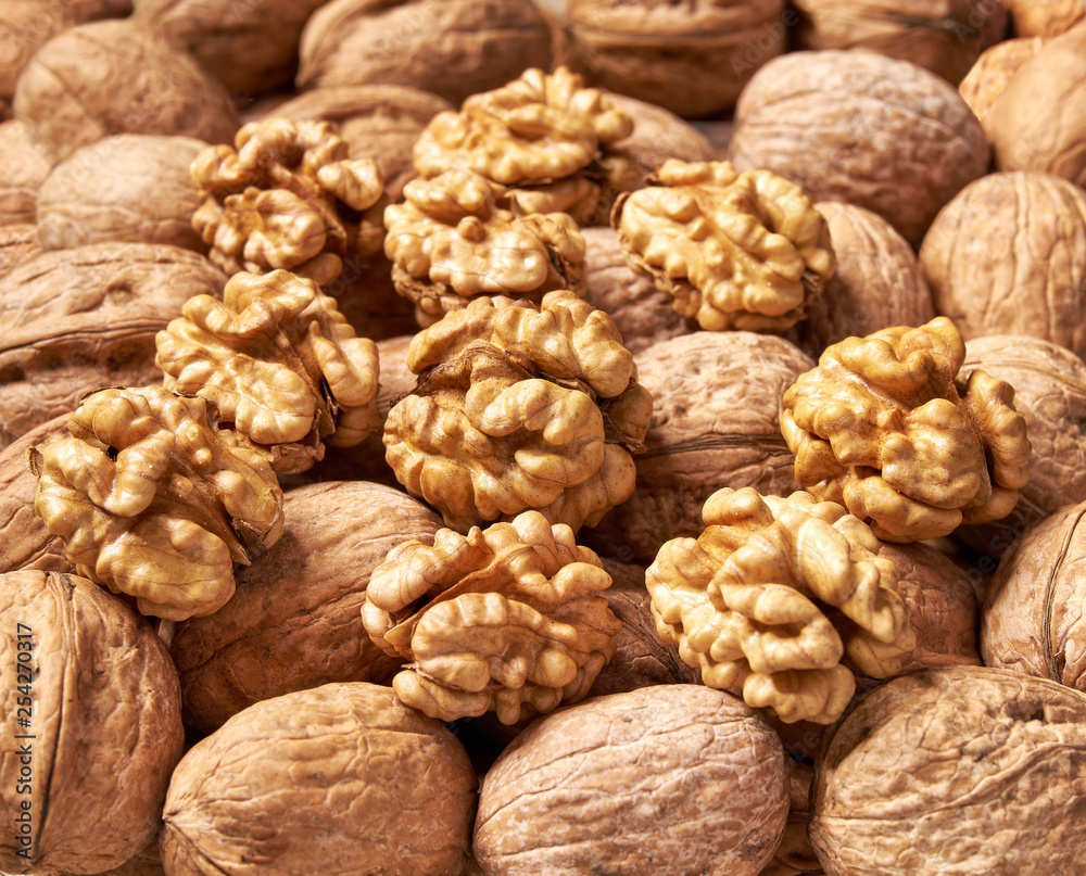 Shelled and unshelled walnuts background close-up. Shelled and unshelled walnuts background close-up.