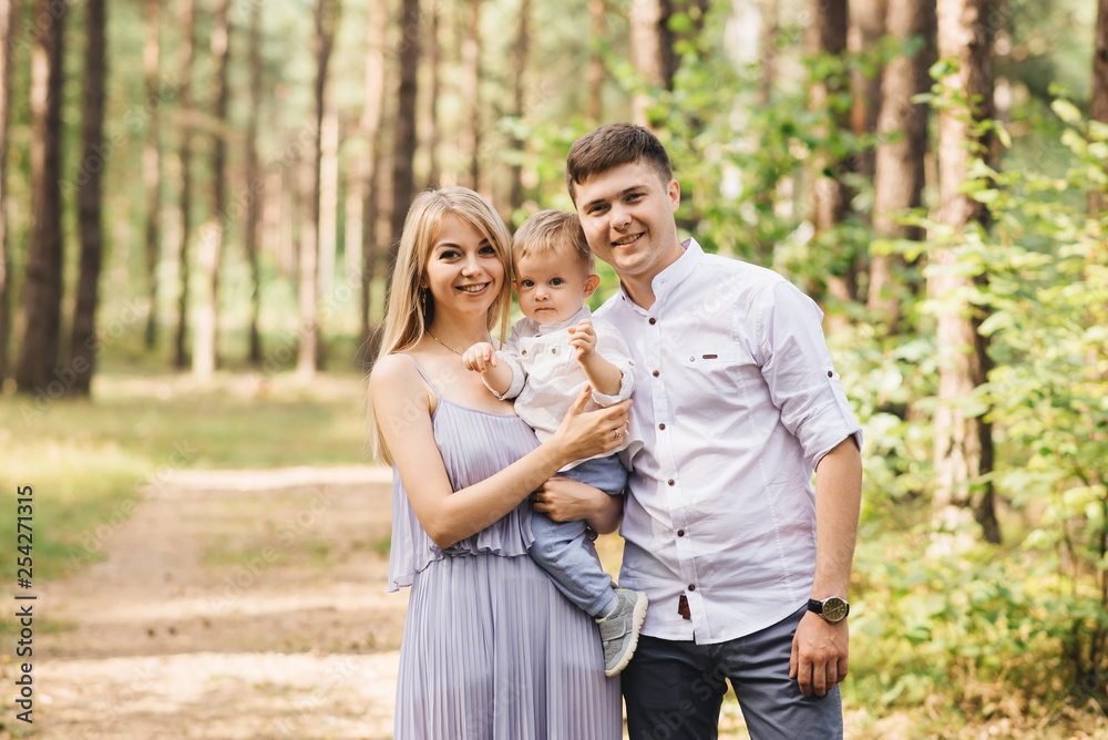 Happy young family spends time together in nature.