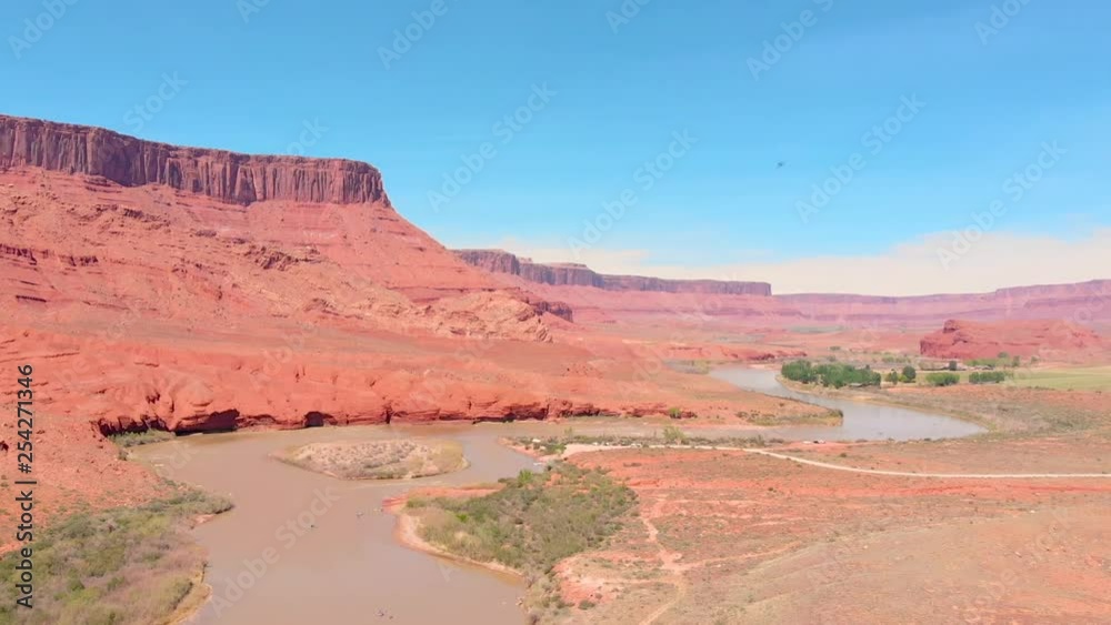 Drone shot fly's over the Colorado River with beautiful red rock mountains in the distance near Moab Utah. Drone shot fly's over the Colorado River with beautiful red rock mountains in the distance near Moab Utah.