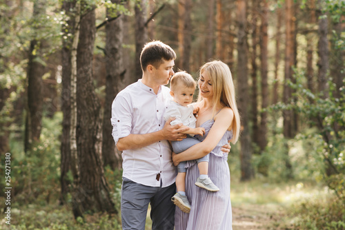 Happy young family spends time together in nature. © ksyusha_yanovich
