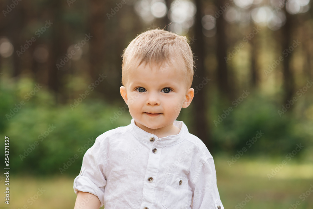 Cute boy playing in nature. Summer in the forest