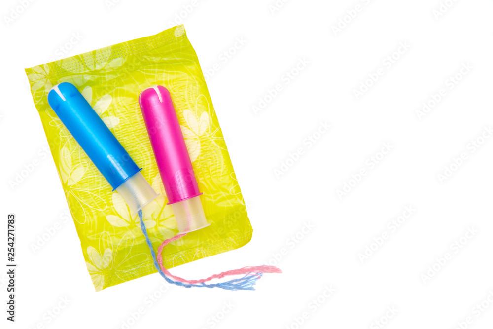 two cotton tampons with pink blue applicartor on menstrual pad isolated on white. Girl cycle period concept. Woman days hygiene protection. Top view, flat lay