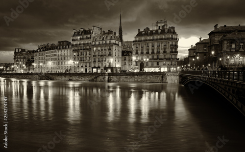 Paris by night.Nocturne view of beautiful Parisian buildings of Ile de la Cite and Seine river. Black and white scenic spot photo. © trialartinf