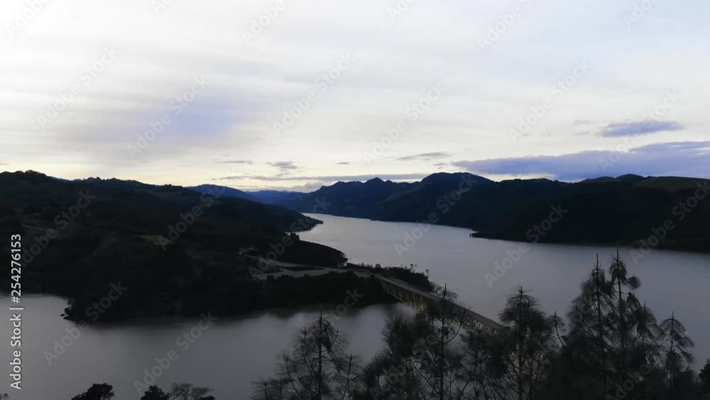 Aerial view from DJI Mavic 2 of lake side marina park in the mountains. Dark day. Somewhat gloomy as the sun sets over the lake. Aerial view from DJI Mavic 2 of lake side marina park in the mountains. Dark day. Somewhat gloomy as the sun sets over the lake.