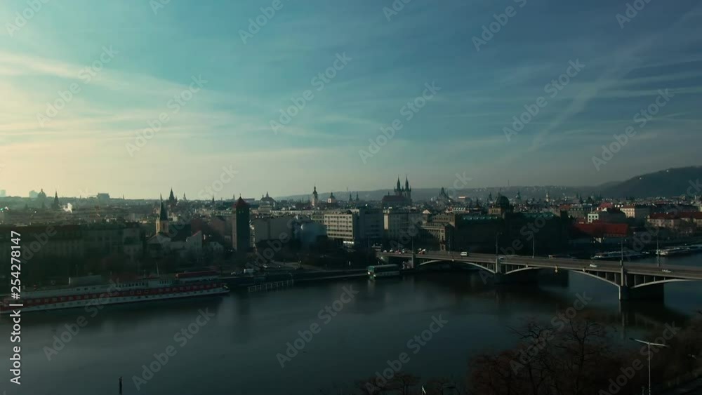 drone flight over prague vlatava river showing bridges castle park and buildings winter sunshine drone flight over prague vlatava river showing bridges castle park and buildings winter sunshine