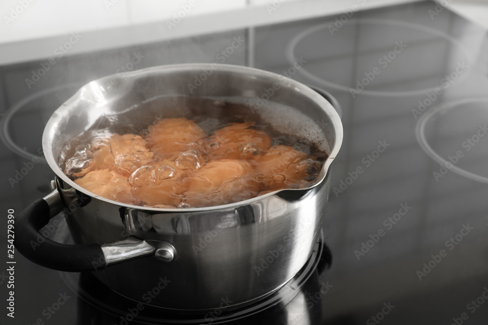 Cooking chicken eggs in pot on electric stove. Space for text Cooking chicken eggs in pot on electric stove. Space for text