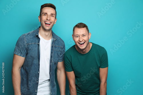 Принти на полотні Man laughing with his friend against color background
