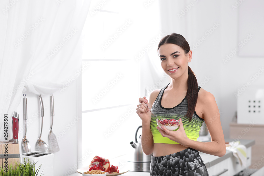 Young woman in fitness clothes having healthy breakfast at home. Space for text Young woman in fitness clothes having healthy breakfast at home. Space for text