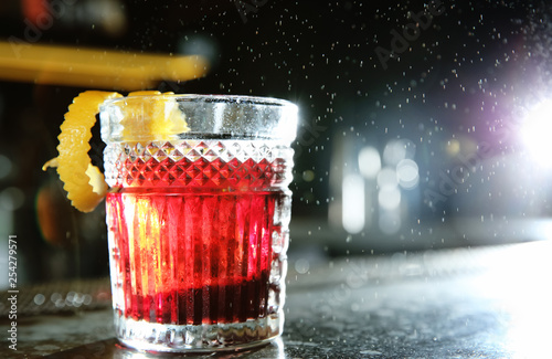 Fresh alcoholic Red Russian cocktail on bar counter. Space for text