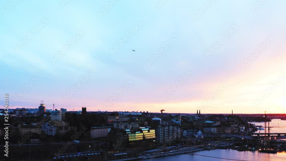Aerial, pan, drone shot, over the sea, of buildings, on the seaside of the city, on a sunny, summer evening, in Stockholm, Sodermanland, Sweden Aerial, pan, drone shot, over the sea, of buildings, on the seaside of the city, on a sunny, summer evening, in Stockholm, Sodermanland, Sweden