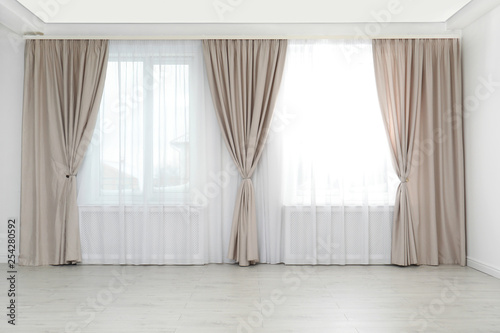 Fototapeta Naklejka Na Ścianę i Meble -  Windows with elegant curtains in empty room