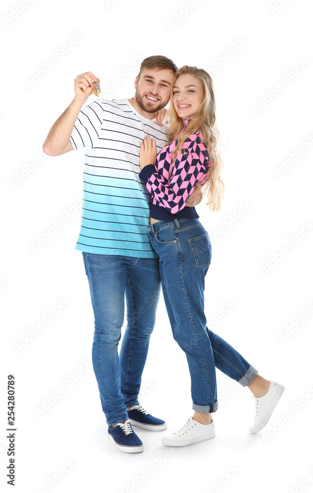 Happy young couple with house key on white background Happy young couple with house key on white background