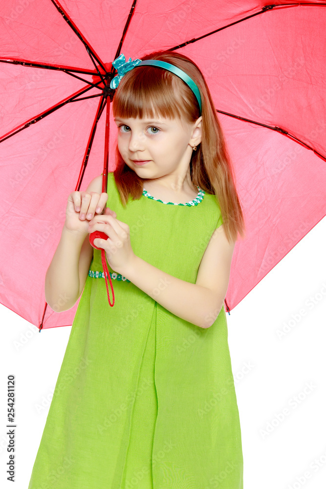 The girl closed from the sun and rain under a red umbrella. Stock Photo