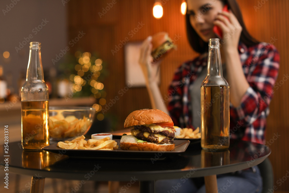 Tasty burger and french fries served on table in cafe