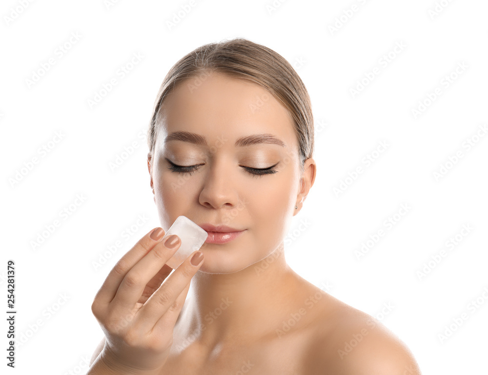 Young woman with ice cube on white background. Skin care