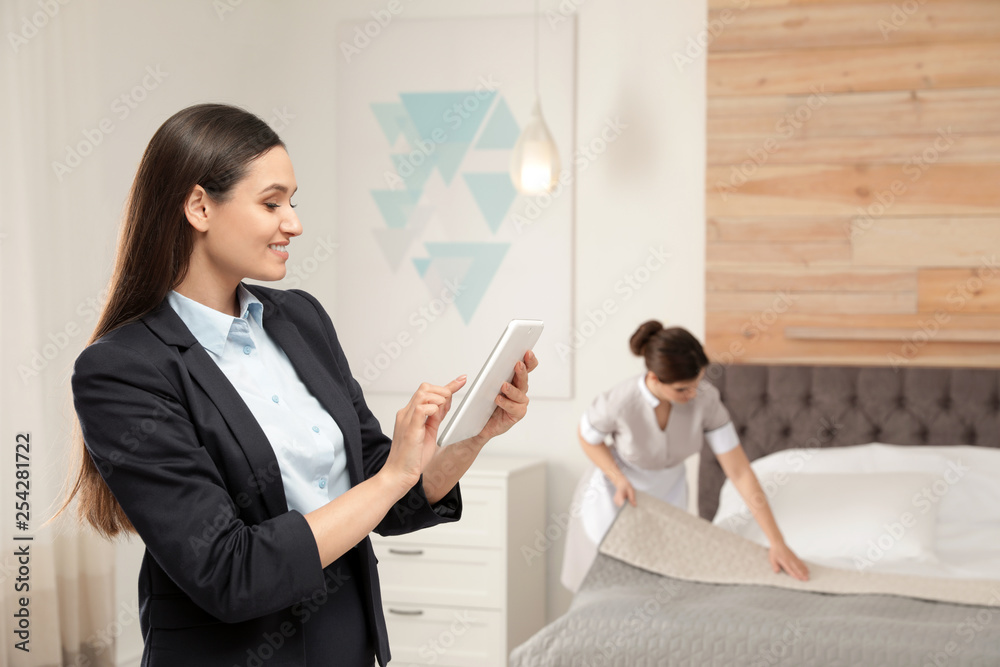 Housekeeping manager checking maid work in hotel room Stock Photo