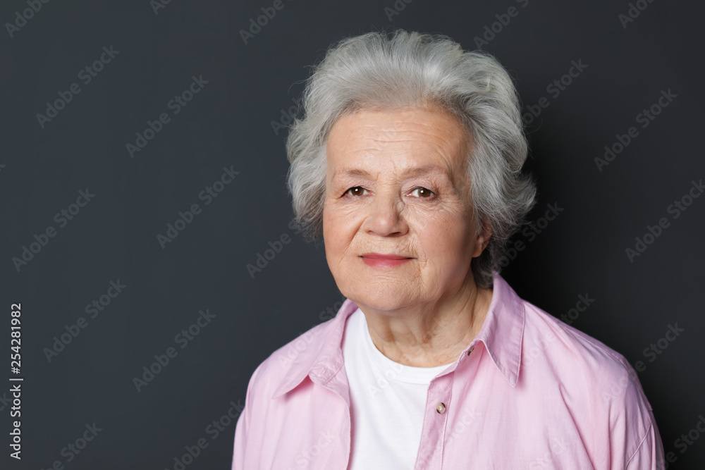 Portrait of mature woman on black background. Space for text Portrait of mature woman on black background. Space for text