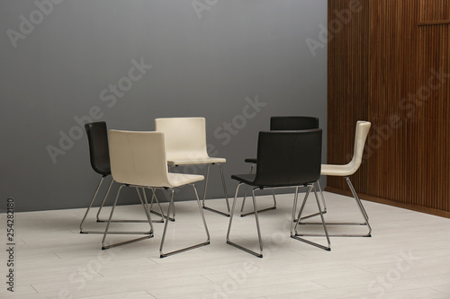 Chairs prepared for group therapy session in office. Meeting room interior