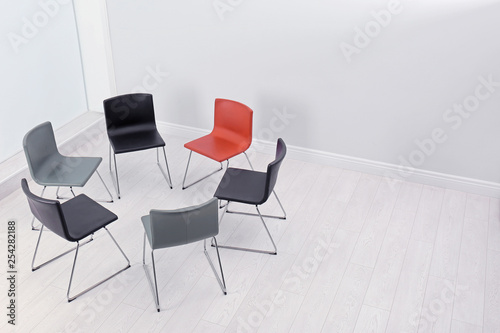 Chairs prepared for group therapy session in office, space for text. Meeting room interior