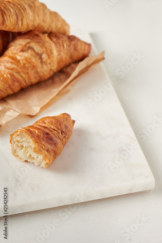 Croissants on the parchment paper, on the marbel board