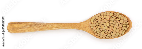 green lentil in wooden spoon isolated on white background. Top view